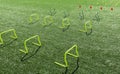 Yellow mini hurdles and orange cones on turf field Royalty Free Stock Photo