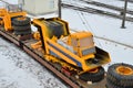 Yellow mining truck disassembled into parts, cab, body, electric motor, drive, wheels, loaded onto a cargo railway platform. Royalty Free Stock Photo