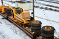 Yellow mining truck disassembled into parts, cab, body, electric motor, drive, wheels, loaded onto a cargo railway platform. Royalty Free Stock Photo