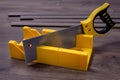 Yellow miter box and hand saw Royalty Free Stock Photo