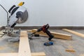 Yellow miter saw cutting wood