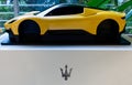 Yellow model of a Maserati sport car with logo on display. Maserati Headquarters. Modena, Italy Royalty Free Stock Photo