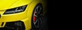 Yellow modern car headlights on black background, free space on right side for text. Royalty Free Stock Photo