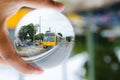 Yellow modern train photography in clear crystal glass ball. Royalty Free Stock Photo