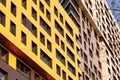 Yellow modern ventilated facade with windows. Part of real estate. Fragment of a new elite residential building or Royalty Free Stock Photo