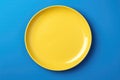 Yellow Monochrome Plate On Blue Background, Top View. Generative AI