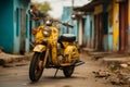 a yellow moped parked on the side of the road