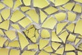 The yellow mosaics wall from the broken pieces of ceramicporcelain tiles. Royalty Free Stock Photo