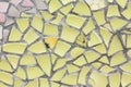 The yellow mosaics wall from the broken pieces of ceramicporcelain tiles. Royalty Free Stock Photo