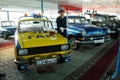 Yellow Moskvich soviet car painted in the colors of the traffic police ussr with a nearby mannequin in police uniform
