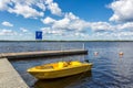 Yellow motor boat on the lake pier