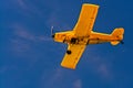 Yellow motorized aircraft in the blue sky Royalty Free Stock Photo