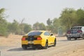 Yellow Mustang sports car on desert