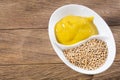 Sauce and seeds of yellow mustard - Sinapis alba Royalty Free Stock Photo