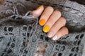 Yellow nail design. Beautiful female hand with manicure with different shades of yellow Royalty Free Stock Photo