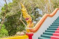 Yellow Naka (giant snake) statue on top of main stair leading to the replica of Phra That In-Kwaen (Hanging Golden