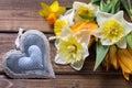 Yellow narcissus and tulips flowers and decorative heart Royalty Free Stock Photo