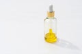 Yellow natural cosmetic product in a glass bottle with a pipette, dropper on a white background, isolated. Serum skin care. Royalty Free Stock Photo
