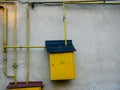 Yellow natural gas pipes and boxes close up on dirty wall Royalty Free Stock Photo