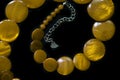 Yellow necklace made of round flat beads on a dark background Royalty Free Stock Photo