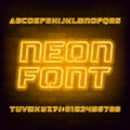 Yellow neon alphabet font. Futuristic light bulb capital letters and numbers. Royalty Free Stock Photo