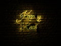 Yellow Neon Sign Text saying Keep it real over a red brick wall