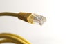 Yellow network cable with RJ45 connector on white background