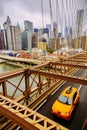 Yellow New York Cab on Brooklyn Bridge with Manhattan view Royalty Free Stock Photo