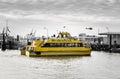 Yellow New York City Water Taxi Arriving in Manhattan East River Docks. Black and White Background Royalty Free Stock Photo