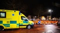 Yellow NHS ambulance driving fast London