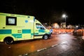 Yellow NHS ambulance driving fast London