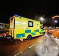 Yellow NHS ambulance driving fast London