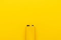 Blank nine-volt battery on the yellow background with copy space