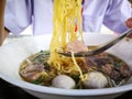 Yellow noodles with meat ball in clear broth or soup Royalty Free Stock Photo