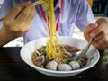 Yellow noodles with meat ball in clear broth or soup Royalty Free Stock Photo