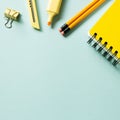 Yellow note pad, pencil, highlighter, cutter, clip on blue background. workspace Royalty Free Stock Photo