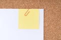 Yellow Note Paper with Paperclip on White Paper Royalty Free Stock Photo