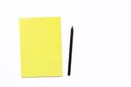 Yellow notebook and black pencil on a white background. Minimal business concept for office. Royalty Free Stock Photo