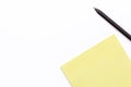 Yellow notebook and black pencil on a white background. Minimal business concept. Royalty Free Stock Photo