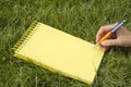 Yellow notebook in grass