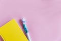 Yellow notebook for notes, funny unicorn pen on pink pastel background. Flat lay. Top view. Copy space Royalty Free Stock Photo