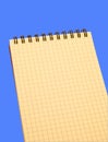 Yellow notebook over blue background