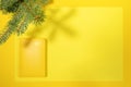 Yellow notepad-organizer on 2021 on empty sheet with copy space and fir branches and shadows above on yellow