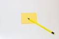 Yellow Notepad and yellow pencil on a white background Royalty Free Stock Photo