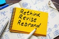 Yellow notepad with words rethink, revise and rebrand.