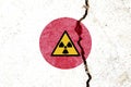 Yellow nuclear warning symbol on the Japan flag on cracked wall background Royalty Free Stock Photo