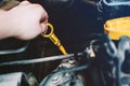 Yellow nylon dipstick check oil level in car engine Royalty Free Stock Photo
