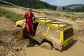 Yellow off road car drowned in muddy terrain Royalty Free Stock Photo