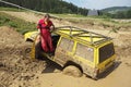 Yellow off road car drowned in muddy terrain Royalty Free Stock Photo