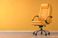 Yellow office chair in yellow interior with space for text